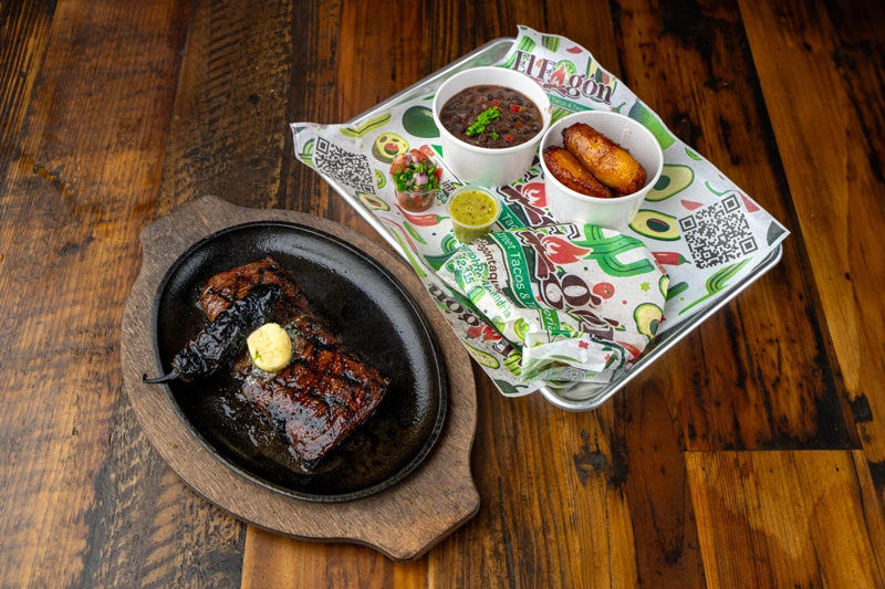 Grilled carne asada steak with sides from El Fogón Taquería.