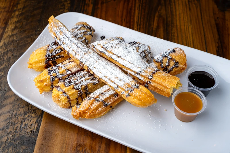 Classic churro dusted with cinnamon sugar from El Fogón Taquería.