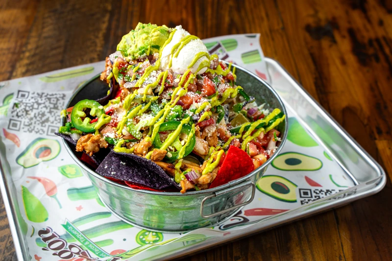 Loaded nachos with toppings at El Fogón Taquería, popular Mexican appetizer.