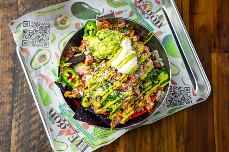 The Best Loaded Nachos In a metal serving bowl - El Fogon